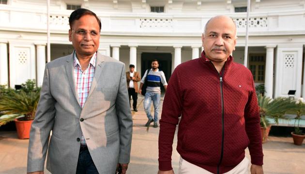 Delhi deputy chief minister Manish Sisodia (right) and health minister Satyendra Jain at the Delhi Assembly on Wednesday.(Sonu Mehta/HT PHOTO)