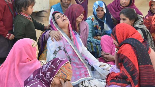 Family members of the boy who was killed in a crossfire in Mathura village on Wednesday. Family members of the boy who was killed in a crossfire in Mathura village on Wednesday.