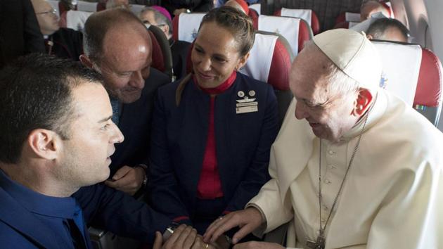 Pope Francis marries flight attendants Carlos Ciuffardi, left, and Paola Podest, center, during a flight from Santiago, Chile, to Iquique, Chile, Thursday. (AP Photo) Pope Francis marries flight attendants Carlos Ciuffardi, left, and Paola Podest, center, during a flight from Santiago, Chile, to Iquique, Chile, Thursday. (AP Photo)