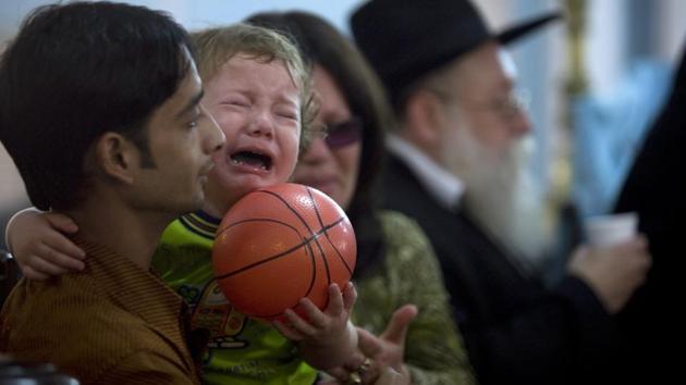 Two-year-old Moshe Holtzberg is held by his grandmother Yehudit Rosenberg as grandfather Shimon Rosenberg looks on during a condolence prayer meeting in a synagogue, for those killed by armed militants at the Jewish centre. The young boy, who was just two days short of turning two when the attack took place,unveiled a memorial dedicated to the victims of the 26/11 attacks, along with Israeli Prime Minister Benjamin Netanyahu. (HT File Photo) Two-year-old Moshe Holtzberg is held by his grandmother Yehudit Rosenberg as grandfather Shimon Rosenberg looks on during a condolence prayer meeting in a synagogue, for those killed by armed militants at the Jewish centre. The young boy, who was just two days short of turning two when the attack took place,unveiled a memorial dedicated to the victims of the 26/11 attacks, along with Israeli Prime Minister Benjamin Netanyahu. (HT File Photo)
