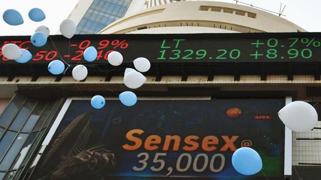 Indian workers release balloons outside the Bombay Stock Exchange (BSE) to celebrate the benchmark 30-share index SENSEX crossing 35,000 points in Mumbai on January 17, 2018. / AFP PHOTO / PUNIT PARANJPE (AFP) Indian workers release balloons outside the Bombay Stock Exchange (BSE) to celebrate the benchmark 30-share index SENSEX crossing 35,000 points in Mumbai on January 17, 2018. / AFP PHOTO / PUNIT PARANJPE (AFP)