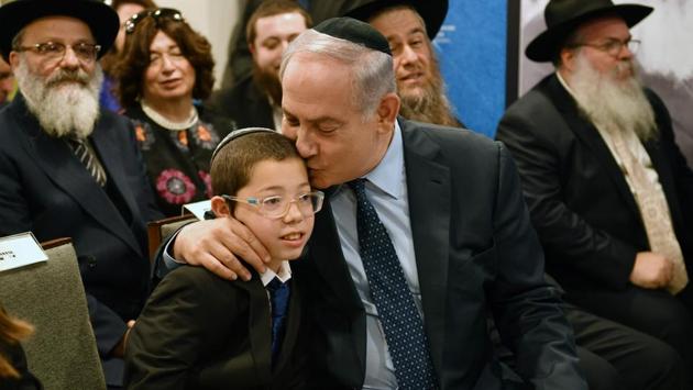 Israel Prime Minister Benjamin Netanyahu (R) sits with Moshe Holtzberg, during a memorial for the 26/11 victims at Nariman House in Mumbai on January 18, 2018. Moshe, who survived the siege at Nariman House arrived on Tuesday morning for the first time since his parents’ death. (Indranil Mukherjee / AFP) Israel Prime Minister Benjamin Netanyahu (R) sits with Moshe Holtzberg, during a memorial for the 26/11 victims at Nariman House in Mumbai on January 18, 2018. Moshe, who survived the siege at Nariman House arrived on Tuesday morning for the first time since his parents’ death. (Indranil Mukherjee / AFP)