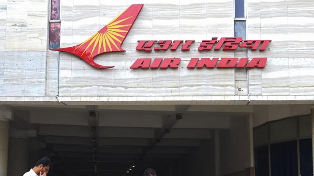 People walk past a sign of Air India outside its headquarters in Mumbai on January 10, 2018. (AFP File Photo) People walk past a sign of Air India outside its headquarters in Mumbai on January 10, 2018. (AFP File Photo)