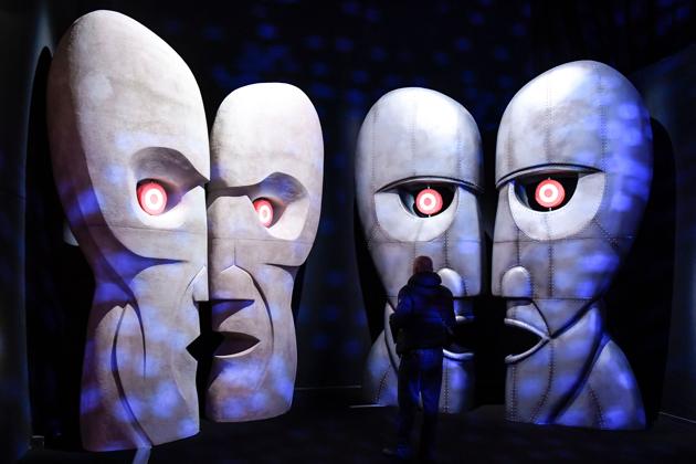 A visitor looks at a replica of the 'The Division Bell Metal Heads' at the Pink Floyd Exhibition. The exhibits comprise installations, instruments and album art work, taking visitors through the band’s origins in the 60s to present day. (Andreas Solaro / AFP) A visitor looks at a replica of the 'The Division Bell Metal Heads' at the Pink Floyd Exhibition. The exhibits comprise installations, instruments and album art work, taking visitors through the band’s origins in the 60s to present day. (Andreas Solaro / AFP)