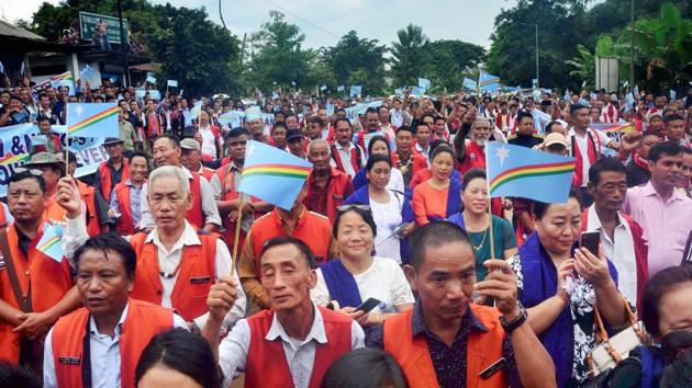Naga tribesmen hold flags to welcome RN Ravi, interlocutor for Naga talks, after his arrival at Dimapur in Nagaland.(PTI File Photo)
