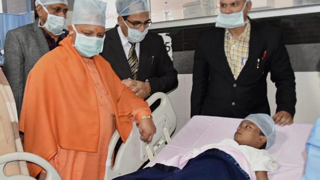 Uttar Pradesh chief minister Yogi Adityanath meets Hrithik Sharma at King George's Medical University in Lucknow on Thursday. (PTI) Uttar Pradesh chief minister Yogi Adityanath meets Hrithik Sharma at King George's Medical University in Lucknow on Thursday. (PTI)