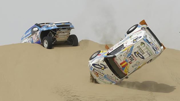 The Mitsubishi rally car driven by Cristina Gutierrez Herrero and Gabriel Moiset Ferrer, both of Spain, flips over between Lima and Pisco. (Ricardo Mazalan / AP) 