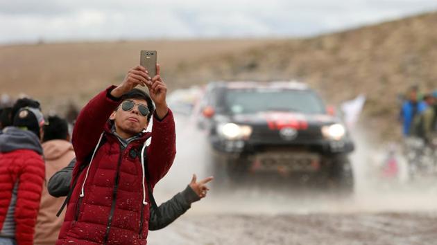 A fan takes a selfie as cars pass by during Stage 6 from Arequipa to La Paz, Bolivia . (Andres Stapff / REUTERS) 