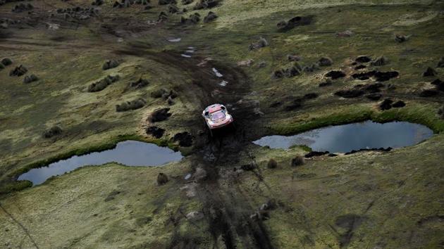 Cyril Despres and David Castera of France drive their Peugeot through a trough between La Paz and Uyuni. (Franck Fife / Pool / REUTERS) 