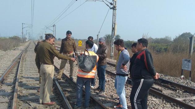 Officials from the Government Railway Police inspect a section of the railway track near Murad Nagar railway station after a 30-year-old man removed fish plates, on Friday.(HT Photo)