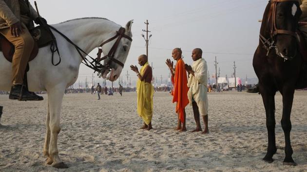 Policemen on horsebacks stand guard as Hindu devotees offer prayers to the Sun god after taking a holy dip at Sangam on “Mauni Amavasya” or New Moon day, the third and most auspicious date of bathing during the month long religious fair “Magh Mela” in Allahabad on January 16, 2018. (Rajesh Kumar Singh / AP) Policemen on horsebacks stand guard as Hindu devotees offer prayers to the Sun god after taking a holy dip at Sangam on “Mauni Amavasya” or New Moon day, the third and most auspicious date of bathing during the month long religious fair “Magh Mela” in Allahabad on January 16, 2018. (Rajesh Kumar Singh / AP)