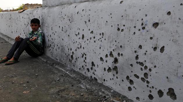 A boy shows splinters of mortar shell fired from the Pakistani side, in Arnia district of Jammu and Kashmir, on Thursday. (Nitin Kanotra/ HT Photo) A boy shows splinters of mortar shell fired from the Pakistani side, in Arnia district of Jammu and Kashmir, on Thursday. (Nitin Kanotra/ HT Photo)