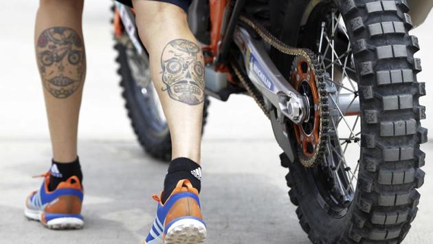 Sam Sunderland, of United Kingdom, pushes his KTM motorbike during technical checks prior to the 2018 Dakar Rally at Las Palmas airbase in Lima, Peru. The 40th edition of the Dakar Rally, the tenth in South America, runs south along the Pacific coast, crossing Bolivia to finish in Cordoba, Argentina on January 20. (Ricardo Mazalan / AP) 