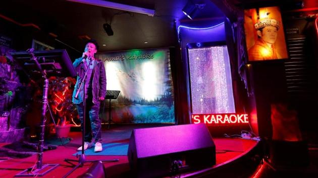 A man sings in a Karaoke bar beside a portrait of King Jigme Khesar Namgyel Wangchuck in Thimphu, Bhutan. For decades Bhutan had no television, no traffic lights and a culture that had barely changed in centuries. But the once-isolated Buddhist country tucked between India and China is changing, and bringing the modern world’s problems in its wake. (Cathal McNaughton / REUTERS) A man sings in a Karaoke bar beside a portrait of King Jigme Khesar Namgyel Wangchuck in Thimphu, Bhutan. For decades Bhutan had no television, no traffic lights and a culture that had barely changed in centuries. But the once-isolated Buddhist country tucked between India and China is changing, and bringing the modern world’s problems in its wake. (Cathal McNaughton / REUTERS)