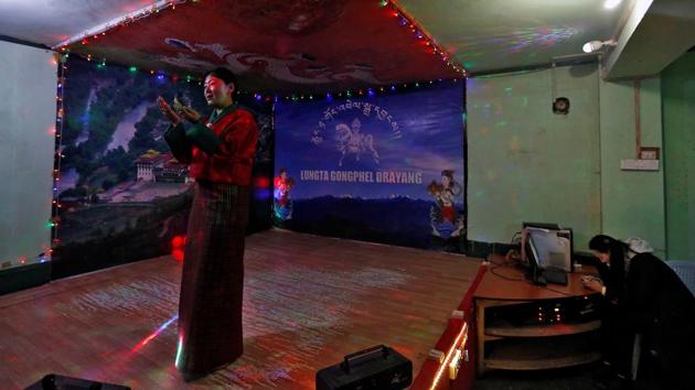 Inside a gaudily lit dance club, guests watch 38-year-old Lhaden sway to songs, usually traditional folk music but occasionally a Bollywood number or two. The divorced mother-of-two, dances until midnight, and like thousands of her compatriots, is struggling to make ends meet. “I’m not happy or sad about things, I have no other choice.” Lhaden, who earns $125 a month said. (Cathal McNaughton / REUTERS) Inside a gaudily lit dance club, guests watch 38-year-old Lhaden sway to songs, usually traditional folk music but occasionally a Bollywood number or two. The divorced mother-of-two, dances until midnight, and like thousands of her compatriots, is struggling to make ends meet. “I’m not happy or sad about things, I have no other choice.” Lhaden, who earns $125 a month said. (Cathal McNaughton / REUTERS)