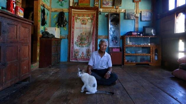 Zeko, 73, poses for a portrait at his home. He says, "I'm happy to have a mobile phone so I can talk to my relatives and children any time I want.” Mobile phones and TV sets are now commonplace even in the Phobjikha Valley, a tourist haven about seven hours’ drive from Thimphu and home to Bhutan’s famed black-necked cranes. (Cathal McNaughton / REUTERS) Zeko, 73, poses for a portrait at his home. He says, "I'm happy to have a mobile phone so I can talk to my relatives and children any time I want.” Mobile phones and TV sets are now commonplace even in the Phobjikha Valley, a tourist haven about seven hours’ drive from Thimphu and home to Bhutan’s famed black-necked cranes. (Cathal McNaughton / REUTERS)