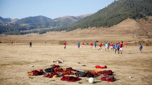 A squad of Buddhist monks has discarded their crimson robes to play football, in Manchester United and Chelsea jerseys. On the streets and even in the countryside, jeans have become as commonplace as the traditional Bhutanese knee-length gho robes for men and the ankle-length kira dresses that women wear. (Cathal McNaughton / REUTERS) A squad of Buddhist monks has discarded their crimson robes to play football, in Manchester United and Chelsea jerseys. On the streets and even in the countryside, jeans have become as commonplace as the traditional Bhutanese knee-length gho robes for men and the ankle-length kira dresses that women wear. (Cathal McNaughton / REUTERS)