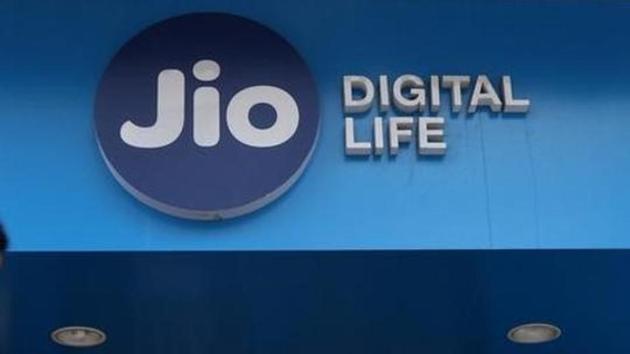 A woman checks her mobile phone as she walks past a mobile store of Reliance Industries' Jio telecoms unit, in Mumbai. (Reuters) A woman checks her mobile phone as she walks past a mobile store of Reliance Industries' Jio telecoms unit, in Mumbai. (Reuters)