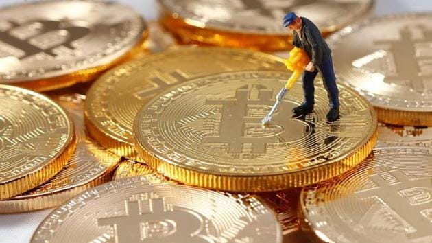 A small toy figure is seen on representations of the Bitcoin virtual currency in this illustration picture. (REUTERS) A small toy figure is seen on representations of the Bitcoin virtual currency in this illustration picture. (REUTERS)