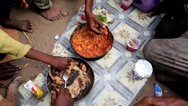 Members of the Ruzaiq family gather around a meal cooked from foraged ingredients outside their hut, near the Red Sea port city of Hodeidah. (Abduljabbar Zeyad / REUTERS) Members of the Ruzaiq family gather around a meal cooked from foraged ingredients outside their hut, near the Red Sea port city of Hodeidah. (Abduljabbar Zeyad / REUTERS)