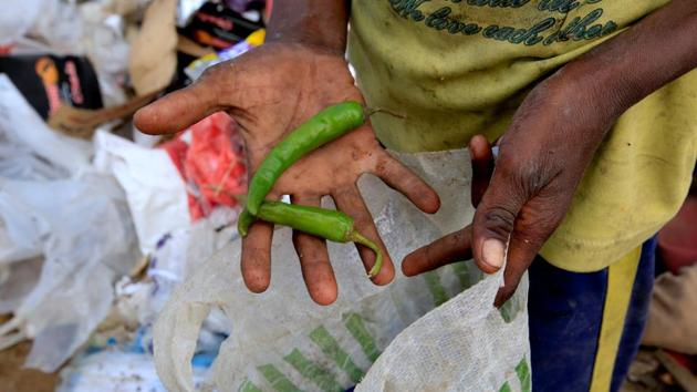 Ayoub holds out green peppers he found in the trash. The war has killed more than 10,000 people, crippled Yemen’s economy, caused a cholera epidemic that has claimed nearly 2,000 lives and pushed the country to the verge of famine. (Abduljabbar Zeyad / REUTERS) Ayoub holds out green peppers he found in the trash. The war has killed more than 10,000 people, crippled Yemen’s economy, caused a cholera epidemic that has claimed nearly 2,000 lives and pushed the country to the verge of famine. (Abduljabbar Zeyad / REUTERS)