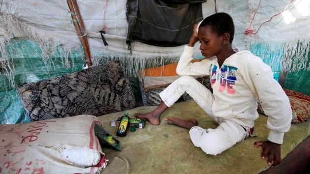Ayoub combs his hair inside his family's hut next to the garbage dump. Apart from picking up food thrown away by better off Yemenis, some displaced people collect metal cans and plastic bottles to sell to merchants for cash to cover daily needs. (Abduljabbar Zeyad / REUTERS) Ayoub combs his hair inside his family's hut next to the garbage dump. Apart from picking up food thrown away by better off Yemenis, some displaced people collect metal cans and plastic bottles to sell to merchants for cash to cover daily needs. (Abduljabbar Zeyad / REUTERS)