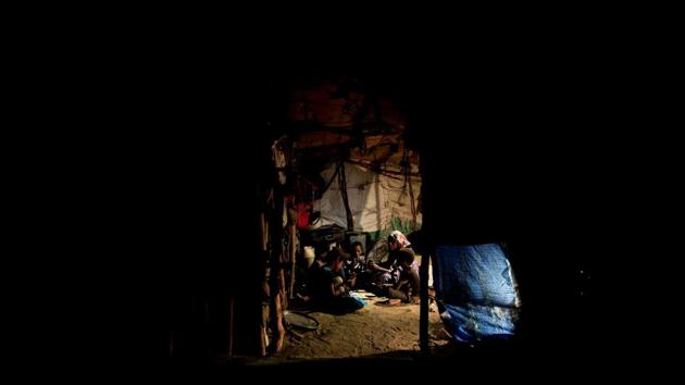 Members of the Ruzaiq family unwind with a game of cards inside their hut. Coalition forces meanwhile have also been advancing along the Red Sea coast, drawing closer to Hodeida, which is a rebel-held city and a key entry point for humanitarian supplies. (Abduljabbar Zeyad / REUTERS) Members of the Ruzaiq family unwind with a game of cards inside their hut. Coalition forces meanwhile have also been advancing along the Red Sea coast, drawing closer to Hodeida, which is a rebel-held city and a key entry point for humanitarian supplies. (Abduljabbar Zeyad / REUTERS)