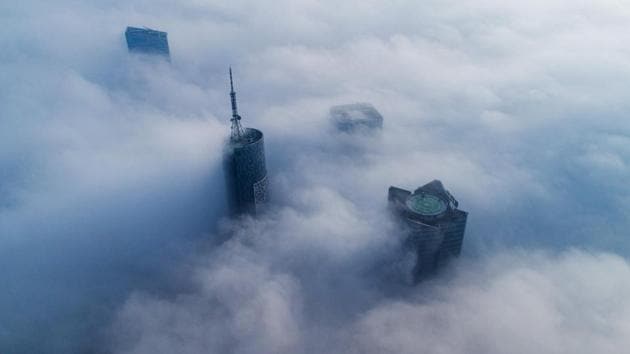 Skyscrapers are seen shrouded in fog in Hefei, in China's Anhui province on January 17. (AFP) Skyscrapers are seen shrouded in fog in Hefei, in China's Anhui province on January 17. (AFP)