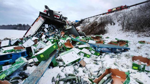 Crates of cucumbers lie scattered in the snow after a cargo truck slid off a snow-packed highway in Germany on January 17. (Bodo Schackow / AFP) Crates of cucumbers lie scattered in the snow after a cargo truck slid off a snow-packed highway in Germany on January 17. (Bodo Schackow / AFP)