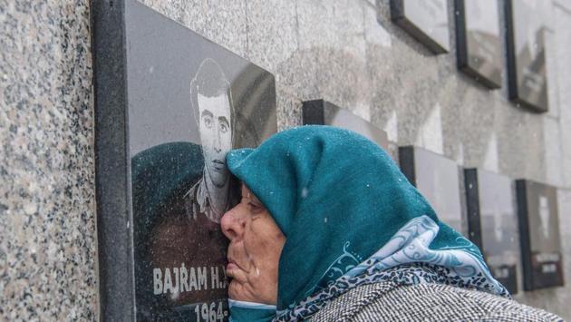 A Kosovo-Albanian woman Vezire Gjeladini, 76, kisses the picture of her son etched into a commemorative plaque on a wall dedicated to victims of the Racak massacre on January 15. In 1999, forty-five Albanian civilians were killed by Serb forces in the village of Racak. (Armend Nimani / AFP) A Kosovo-Albanian woman Vezire Gjeladini, 76, kisses the picture of her son etched into a commemorative plaque on a wall dedicated to victims of the Racak massacre on January 15. In 1999, forty-five Albanian civilians were killed by Serb forces in the village of Racak. (Armend Nimani / AFP)