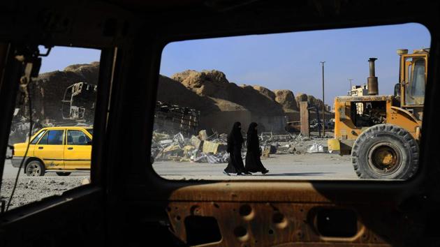 Women walk along a road in the northern Syrian city of Raqqa on January 16, still in tatters after a military operation last year defeated the Islamic State group but also left the city completely disfigured. (Delil Souleiman / AFP) Women walk along a road in the northern Syrian city of Raqqa on January 16, still in tatters after a military operation last year defeated the Islamic State group but also left the city completely disfigured. (Delil Souleiman / AFP)