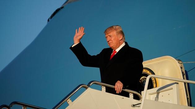 US President Donald Trump waves as he steps off Air Force One upon return to Andrews Air Force in Maryland on January 18.(AFP Photo)