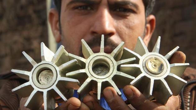 A villager displays mortar shell pieces allegedly fired on a residential area from the Pakistan side at the India-Pakistan international border at Pindi Camp in Arnia Sector about 40km from Jammu on January 18, 2018. (PTI) A villager displays mortar shell pieces allegedly fired on a residential area from the Pakistan side at the India-Pakistan international border at Pindi Camp in Arnia Sector about 40km from Jammu on January 18, 2018. (PTI)