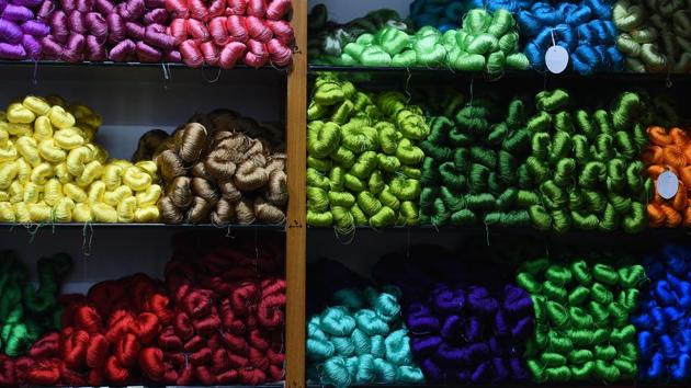 Coils of silk yarn line a store’s shelves in Varanasi. The first signs of change came in 1985 as weavers reeled from a spike in silk prices and synthetic viscose yarn began taking over markets. The powerloom’s appearance on the scene soon after, changed the business ever since. (Raj K Raj / HT Photo) Coils of silk yarn line a store’s shelves in Varanasi. The first signs of change came in 1985 as weavers reeled from a spike in silk prices and synthetic viscose yarn began taking over markets. The powerloom’s appearance on the scene soon after, changed the business ever since. (Raj K Raj / HT Photo)