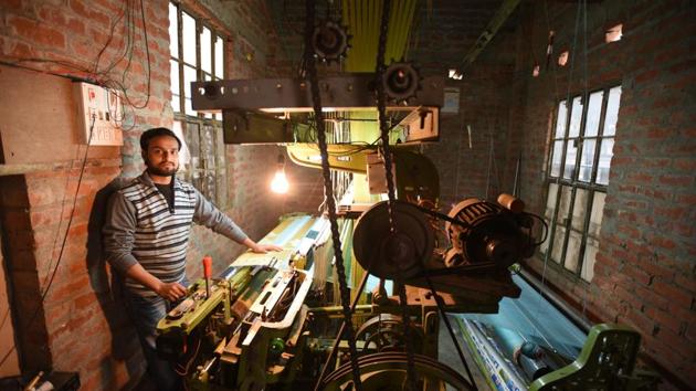 Mohammed Imraan shows his powerloom at a a workshop. The complexity of the design often demands additional weavers or the help of the women in the household to manage yarn to save time, but this comes with no extra income. In contrast the powerloom generates twice the income of a handloom, and is less laborious. (Raj K Raj / HT Photo) Mohammed Imraan shows his powerloom at a a workshop. The complexity of the design often demands additional weavers or the help of the women in the household to manage yarn to save time, but this comes with no extra income. In contrast the powerloom generates twice the income of a handloom, and is less laborious. (Raj K Raj / HT Photo)