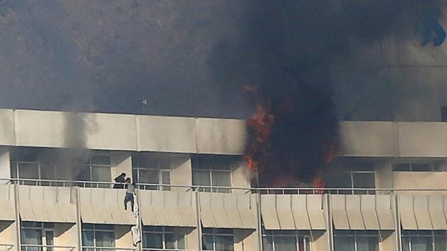 A man tries to escape from a balcony at Kabul's Intercontinental Hotel during an attack by gunmen in Kabul, Afghanistan. (REUTERS) A man tries to escape from a balcony at Kabul's Intercontinental Hotel during an attack by gunmen in Kabul, Afghanistan. (REUTERS)