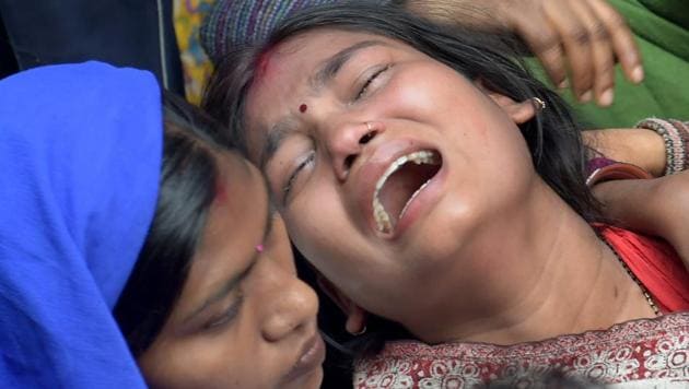Relatives of a Bawana fire victim mourns at her house in New Delhi on Sunday. (PTI Photo) Relatives of a Bawana fire victim mourns at her house in New Delhi on Sunday. (PTI Photo)