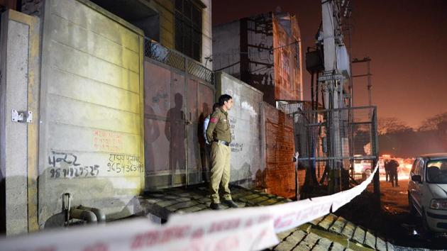 Police stand guard in front of a plastic factory in the Bawana industrial area in Delhi after a fire killed at least 17 workers. (AFP Photo) Police stand guard in front of a plastic factory in the Bawana industrial area in Delhi after a fire killed at least 17 workers. (AFP Photo)