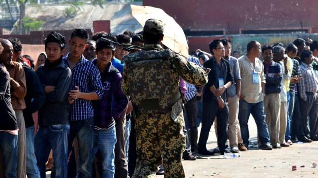 A security officer walks past Naga tribal voters standing in queue at a polling station in Dimapur. Elections in Nagaland will be held on February 27. (AFP File Photo) A security officer walks past Naga tribal voters standing in queue at a polling station in Dimapur. Elections in Nagaland will be held on February 27. (AFP File Photo)