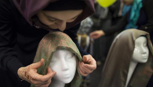 A Muslim woman ties a head scarf onto the head of a mannequin. A school in east London was planning to extend a ban on hijab but has chosen to withdraw the plans. (AP / Representative Photo) A Muslim woman ties a head scarf onto the head of a mannequin. A school in east London was planning to extend a ban on hijab but has chosen to withdraw the plans. (AP / Representative Photo)