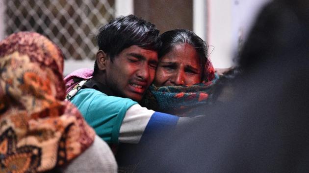 A family cries at the Maharaishi Valmiki Hospital in Outer Delhi where people injured in a factory fire were brought in. At least 17 people died in the fire in Bawana. (Sanchit Khanna/ HT Photo) A family cries at the Maharaishi Valmiki Hospital in Outer Delhi where people injured in a factory fire were brought in. At least 17 people died in the fire in Bawana. (Sanchit Khanna/ HT Photo)