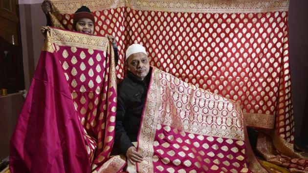 Master weaver Haji Anwar Ahmad, 60, lays out a pink silk Banarasi sari similar to the one said to have been woven by him, and worn by Anushka Sharma at her reception. In the times of lehengas and lighter weaves, the actor’s choice of this classic handloom has generated conversation and demand, but its weavers find themselves being flushed out by a changing market and technological obsolescence. (Raj K Raj / HT Photo) Master weaver Haji Anwar Ahmad, 60, lays out a pink silk Banarasi sari similar to the one said to have been woven by him, and worn by Anushka Sharma at her reception. In the times of lehengas and lighter weaves, the actor’s choice of this classic handloom has generated conversation and demand, but its weavers find themselves being flushed out by a changing market and technological obsolescence. (Raj K Raj / HT Photo)