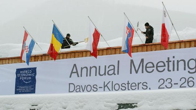 Workers shovel snow from the roof of the congress centre, the venue of the upcoming World Economic Forum (WEF) in the Swiss mountain resort of Davos, Switzerland. (REUTERS) Workers shovel snow from the roof of the congress centre, the venue of the upcoming World Economic Forum (WEF) in the Swiss mountain resort of Davos, Switzerland. (REUTERS)
