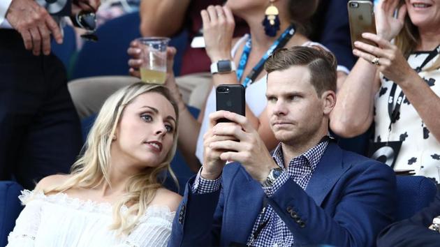 Australia cricket team captain Steve Smith and his fiancee Dani Willis watch the Australian Open fourth round match between Novak Djokovic and Chung Hyeon. (Getty Images) 