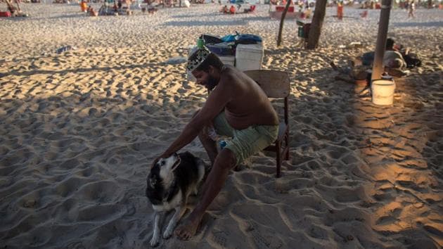 It seems a precarious existence but Marcio, 44, can never see himself living another way. “People pay exorbitant rents to live in front of the sea. I don’t have any bills and I live very well here,” he told Agence France-Presse, waving a hand at the white sand and the islands sparkling on the horizon. (Mauro Pimentel / AFP) It seems a precarious existence but Marcio, 44, can never see himself living another way. “People pay exorbitant rents to live in front of the sea. I don’t have any bills and I live very well here,” he told Agence France-Presse, waving a hand at the white sand and the islands sparkling on the horizon. (Mauro Pimentel / AFP)