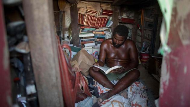 Despite the idyllic setting, space inside is tight - about three square meters. Marcio, single and with no children, lives with a pile of books and some golf clubs, his passions after fishing. His bed? A sleeping bag on the ground. His bathroom? The firemen’s station about 30m away, where he can use the facilities for less than a dollar. (Mauro Pimentel / AFP) Despite the idyllic setting, space inside is tight - about three square meters. Marcio, single and with no children, lives with a pile of books and some golf clubs, his passions after fishing. His bed? A sleeping bag on the ground. His bathroom? The firemen’s station about 30m away, where he can use the facilities for less than a dollar. (Mauro Pimentel / AFP)