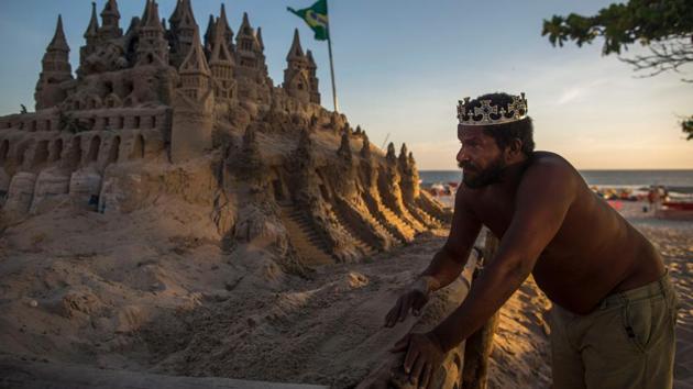He would like his works not to be so ephemeral. Rain can destroy in a few minutes the 10 or 20 hours’ work it takes him to complete one of his fairytale castles. An optimist by nature, Marcio hopes to be able to realize his great dream next year, to make sculptures using other materials, at a friend’s place. (Mauro Pimentel / AFP) He would like his works not to be so ephemeral. Rain can destroy in a few minutes the 10 or 20 hours’ work it takes him to complete one of his fairytale castles. An optimist by nature, Marcio hopes to be able to realize his great dream next year, to make sculptures using other materials, at a friend’s place. (Mauro Pimentel / AFP)