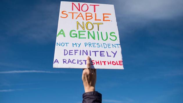 A woman holds up a sign during the march in Washington. Trump dismissed the suggestion that his presidency has been bad for women. He tweeted Saturday that it was a “perfect day” for women to march to celebrate the “economic success and wealth creation” of his first year in office. (Andrew Caballero-Reynolds / AFP) A woman holds up a sign during the march in Washington. Trump dismissed the suggestion that his presidency has been bad for women. He tweeted Saturday that it was a “perfect day” for women to march to celebrate the “economic success and wealth creation” of his first year in office. (Andrew Caballero-Reynolds / AFP)