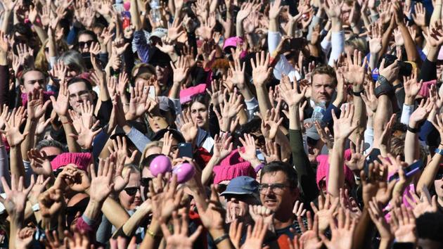 Protesters raise their hands as a show of support during a rally in California. (AFP) Protesters raise their hands as a show of support during a rally in California. (AFP)