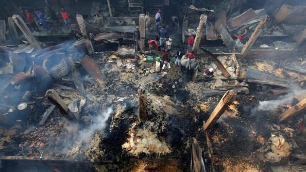 A man pours water as he tries to extinguish a fire that broke out at a marketplace on the outskirts of Kolkata on Monday. (Rupak de Chowdhuri / REUTERS) A man pours water as he tries to extinguish a fire that broke out at a marketplace on the outskirts of Kolkata on Monday. (Rupak de Chowdhuri / REUTERS)